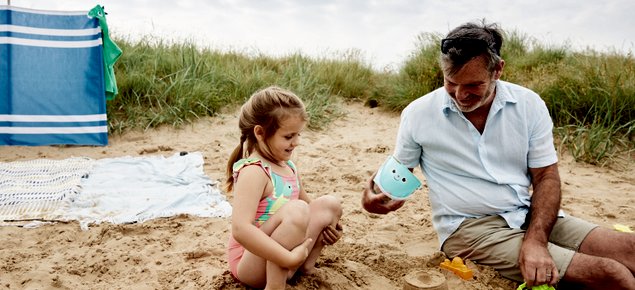 Father and daughter playing on the beach
